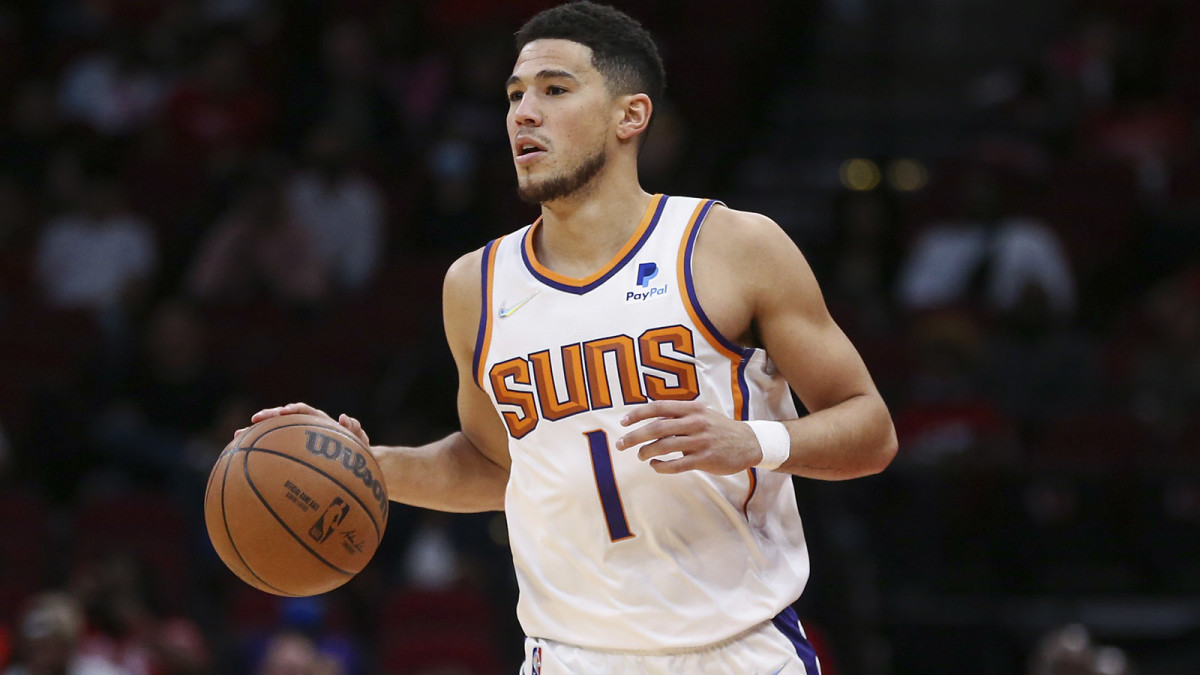 Phoenix Suns guard Devin Booker (1) brings the ball up the court during the first quarter against the Houston Rockets.