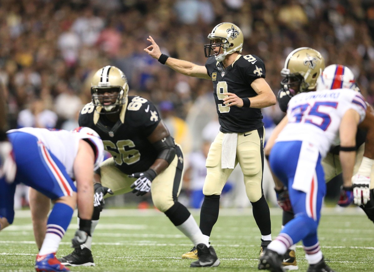 New Orleans Saints quarterback Drew Brees (9) prior to the snap against the Buffalo Bills in 2013. Mandatory Credit: Crystal LoGiudice-USA TODAY