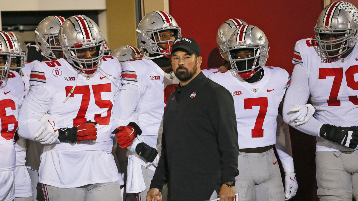 Ohio State coach Ryan Day stands with his team