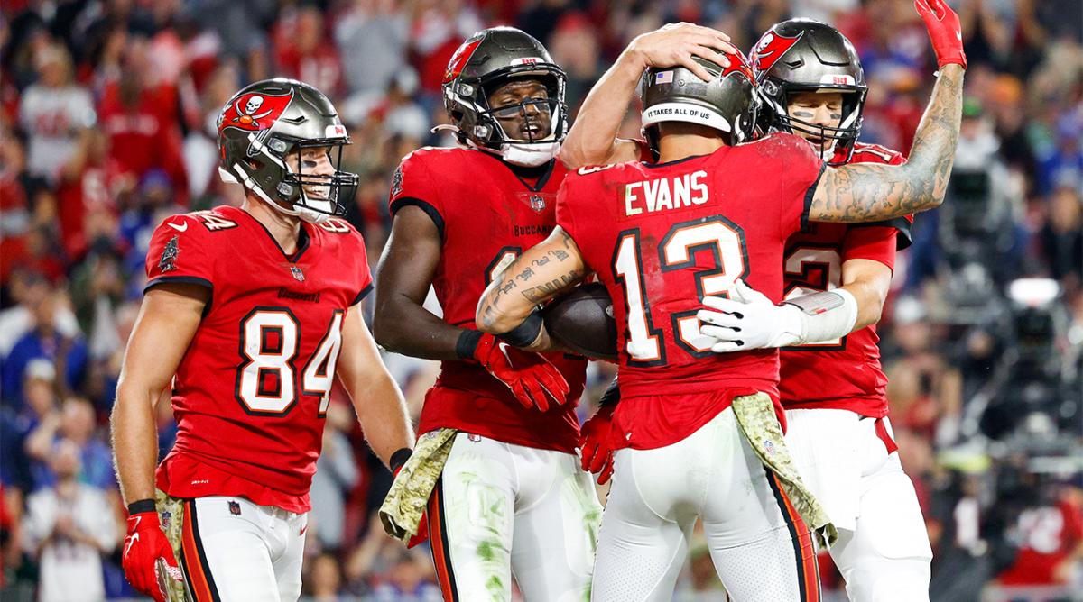 Nov 22, 2021; Tampa, Florida, USA; Tampa Bay Buccaneers quarterback Tom Brady (12) congratulates wide receiver Mike Evans (13) after scoring a touchdown in the second half against the New York Giants at Raymond James Stadium.