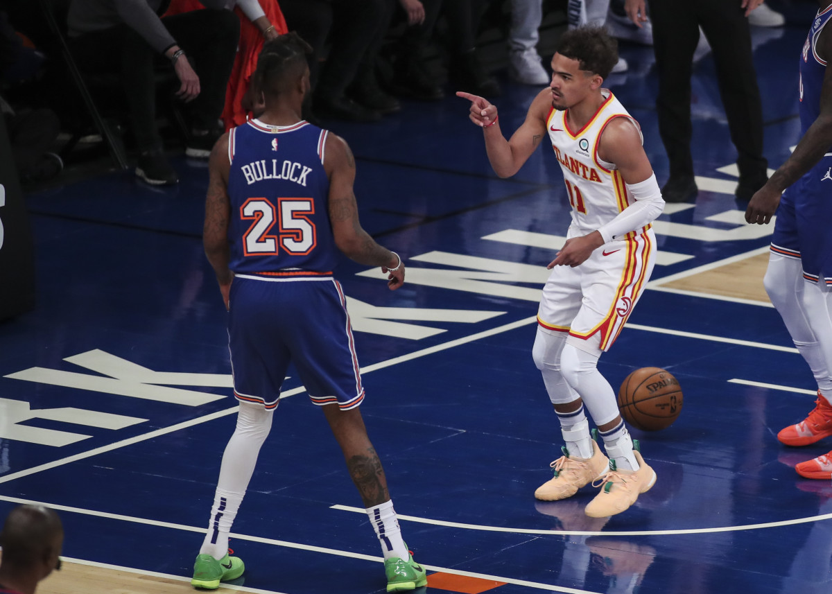 Atlanta Hawks guard Trae Young (11) points to New York Knicks forward Reggie Bullock (25) after scoring in the first quarter during game five in the first round of the 2021 NBA Playoffs. at Madison Square Garden.