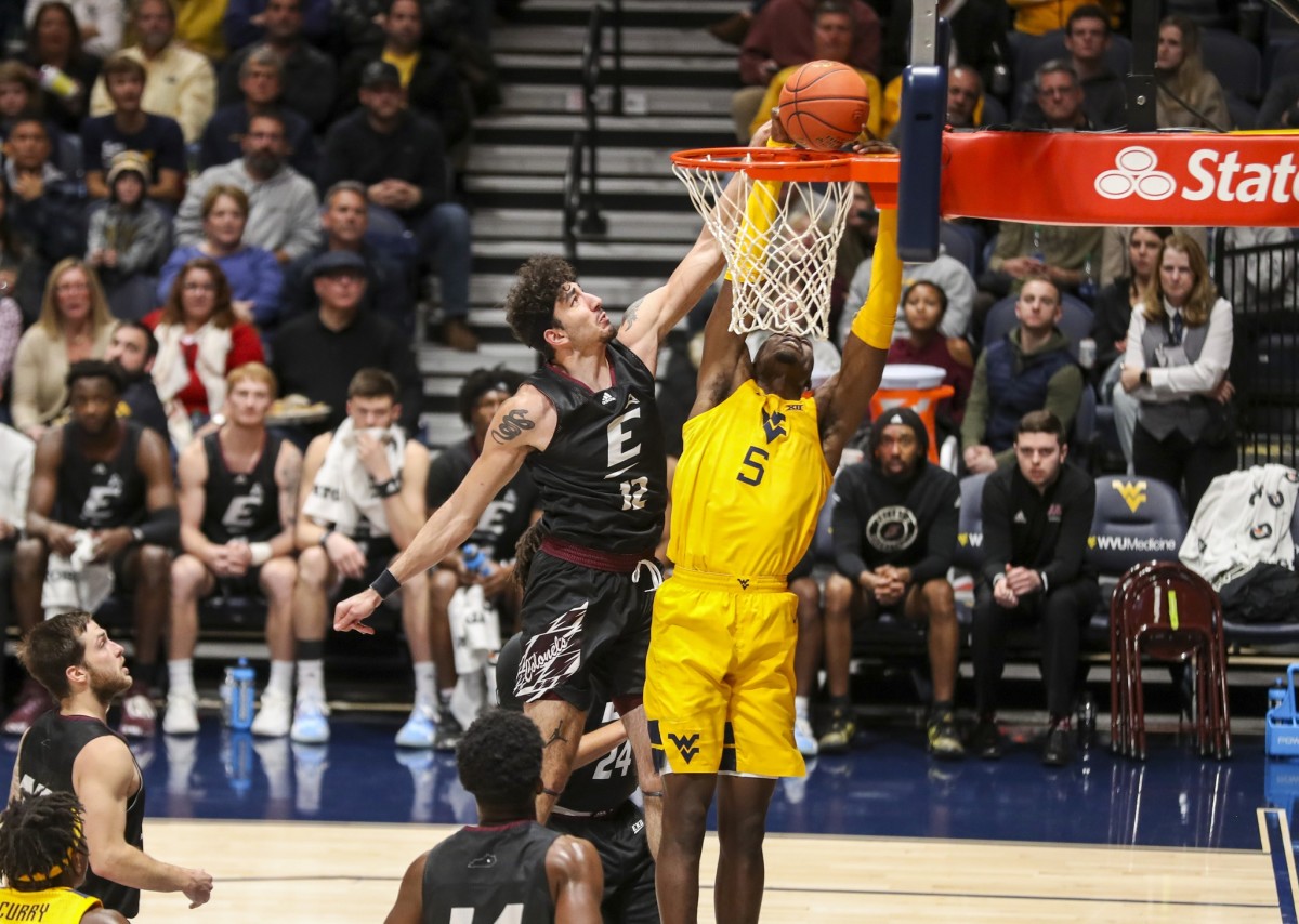 Nov 26, 2021; Morgantown, West Virginia, USA; West Virginia Mountaineers forward Dimon Carrigan (5) attempts to dunk the ball and is defended by Eastern Kentucky Colonels forward Michael Wardy (12) during the first half at WVU Coliseum.