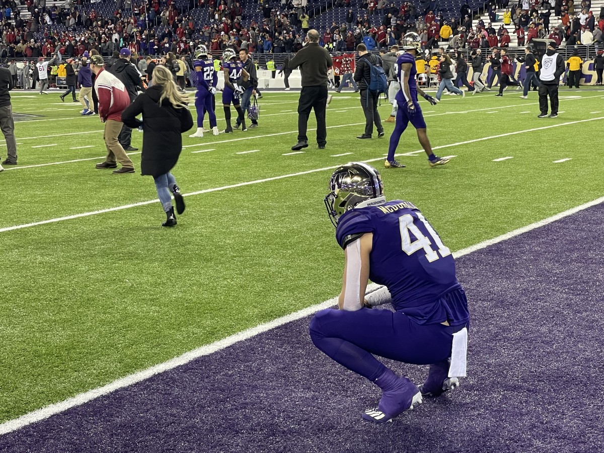 Outside linebacker Cooper McDonald watches the aftermath of an Apple Cup loss.