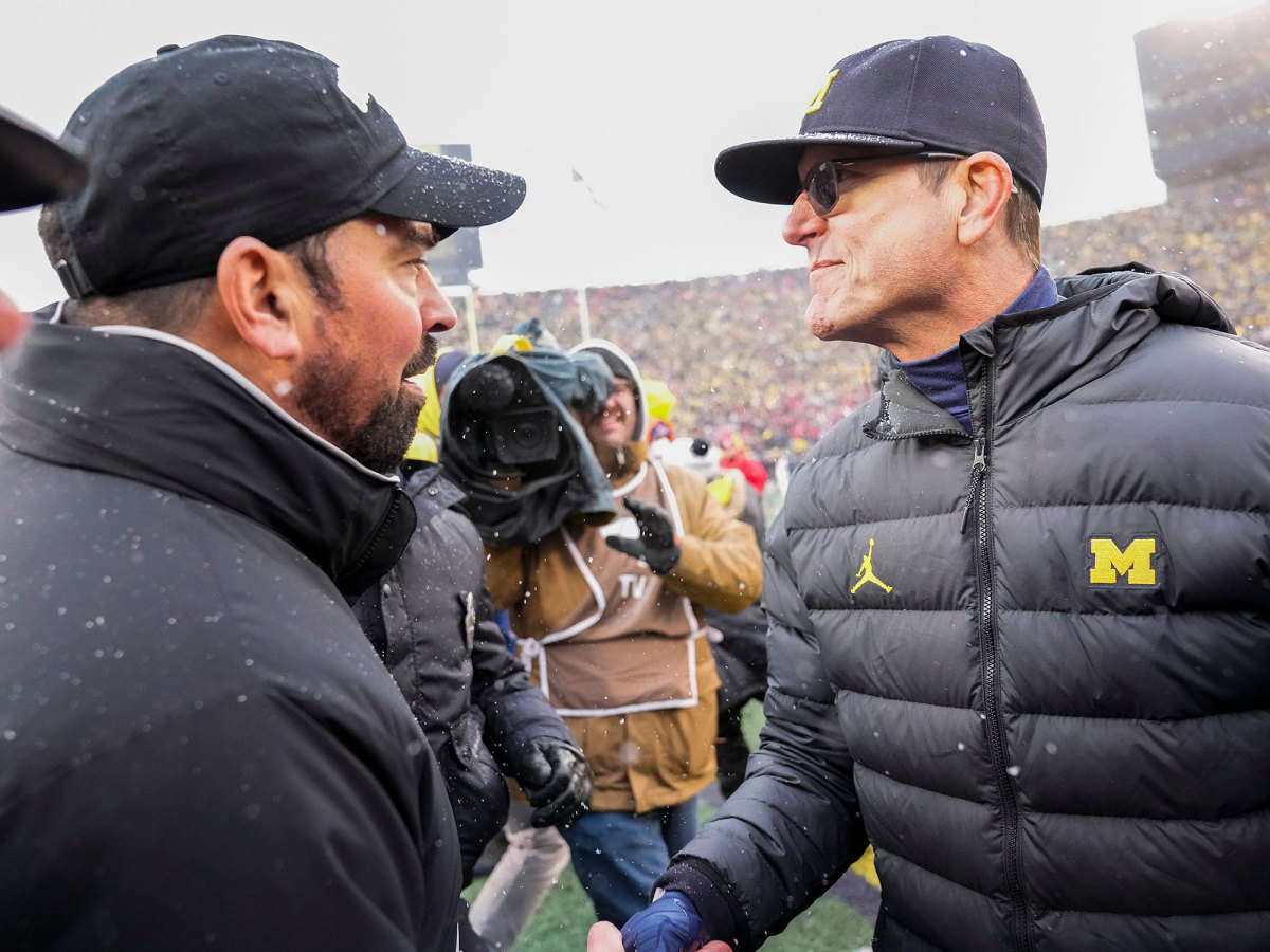 Ryan Day and Jim Harbaugh shake hands after Michigan's win