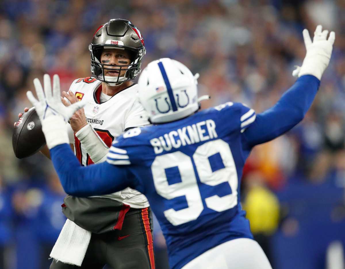 Tampa Bay Buccaneers quarterback Tom Brady (12) looks for a receiver as Indianapolis Colts defensive tackle DeForest Buckner (99) looks for a sack, Sunday, Nov. 28, 2021, during a game against the Tampa Bay Buccaneers at Lucas Oil Stadium in Indianapolis.