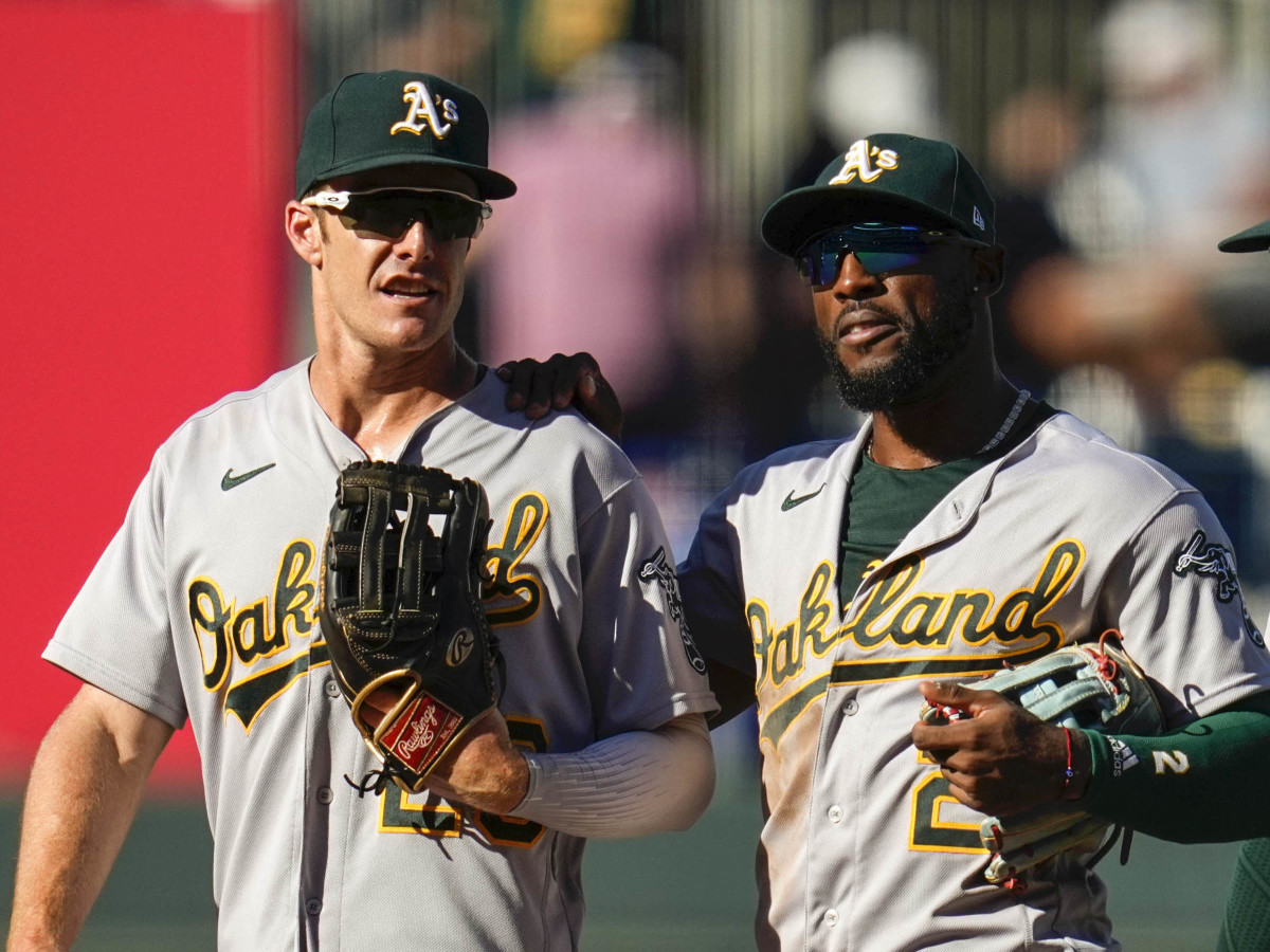 Oakland Athletics left fielder Mark Canha (20) and center fielder Starling Marte (2) and right fielder Chad Pinder (4) react after defeating the Kansas City Royals at Kauffman Stadium.