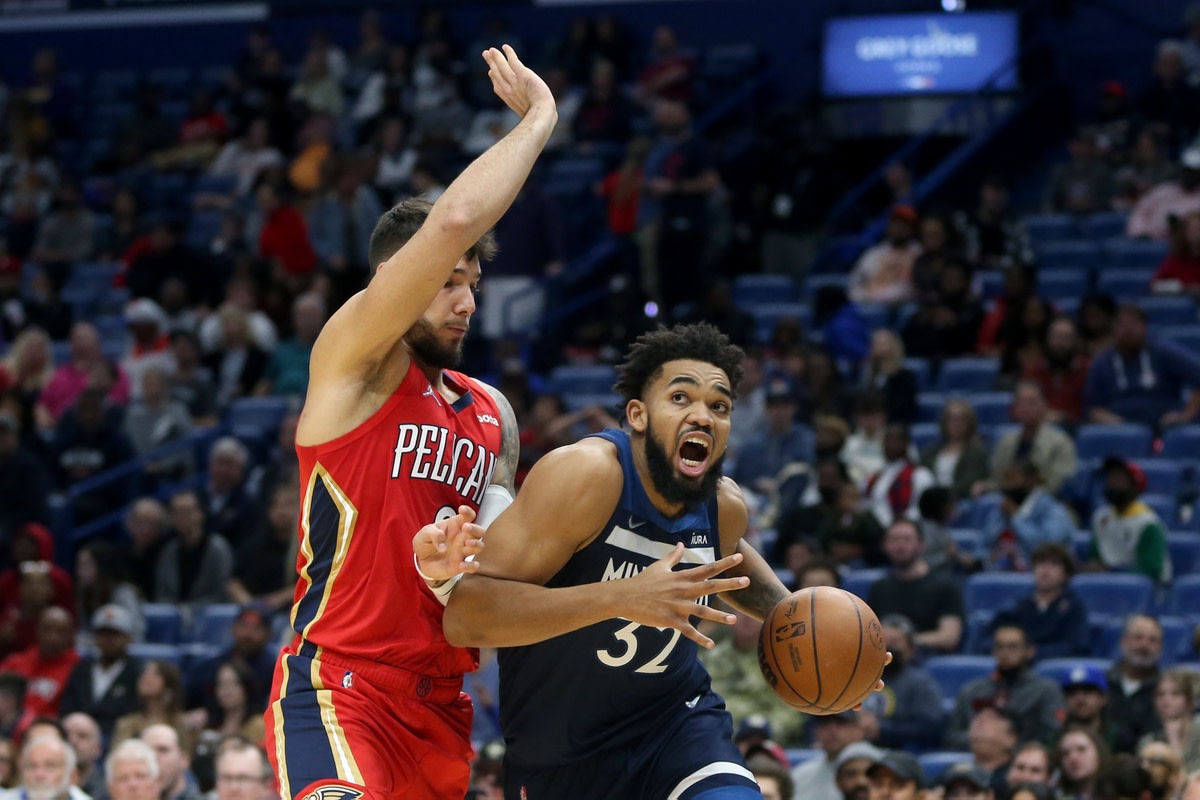 Nov 22, 2021; New Orleans, Louisiana, USA; Minnesota Timberwolves center Karl-Anthony Towns (32) drives around New Orleans Pelicans center Willy Hernangomez (9) in the second quarter at the Smoothie King Center. Mandatory Credit: Chuck Cook-USA TODAY Sports