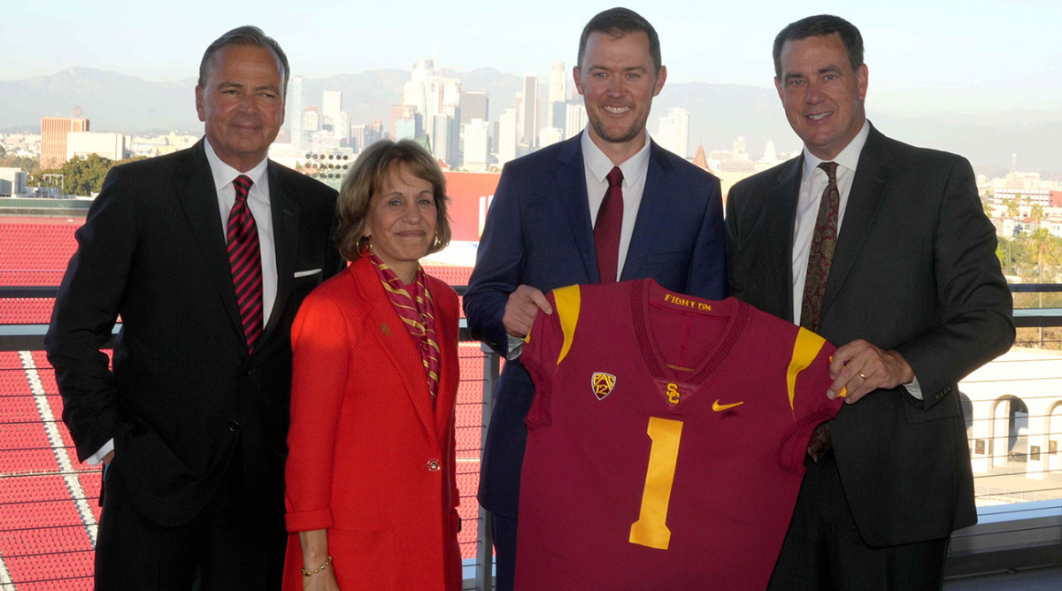 Southern California Trojans board of trustees chairman Rick Caruso, president Carol Folt, Lincoln Riley and athletic director Mike Bohn pose with a jersey.