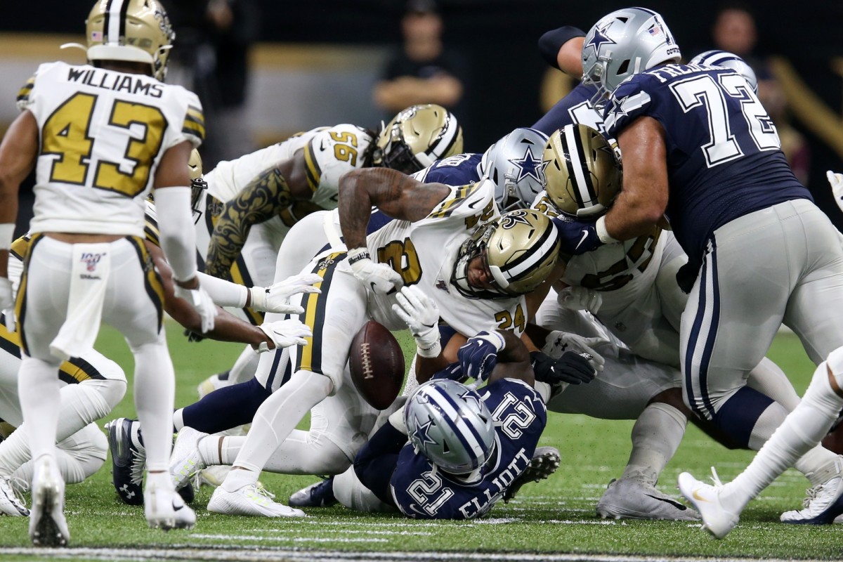 Dallas Cowboys running back Ezekiel Elliott (21) fumbles against the New Orleans Saints. Mandatory Credit: Chuck Cook-USA TODAY Sports