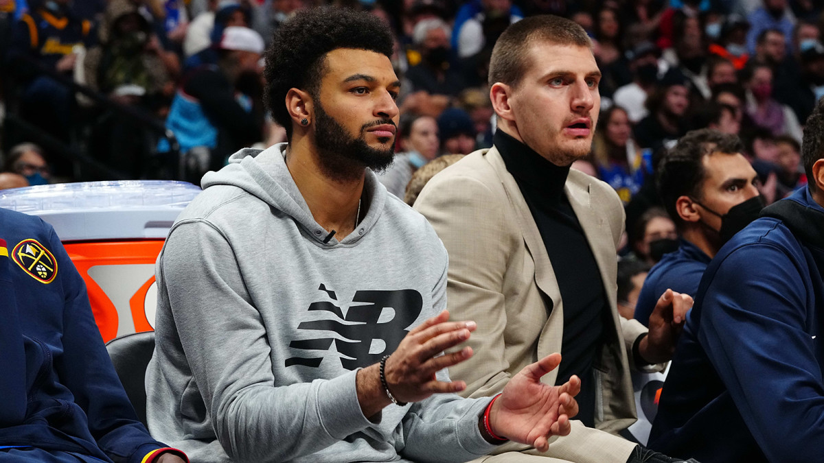 Denver Nuggets guard Jamal Murray (27) and Denver Nuggets center Nikola Jokic (15) on the bench in the third quarter against the Chicago Bulls at Ball Arena.