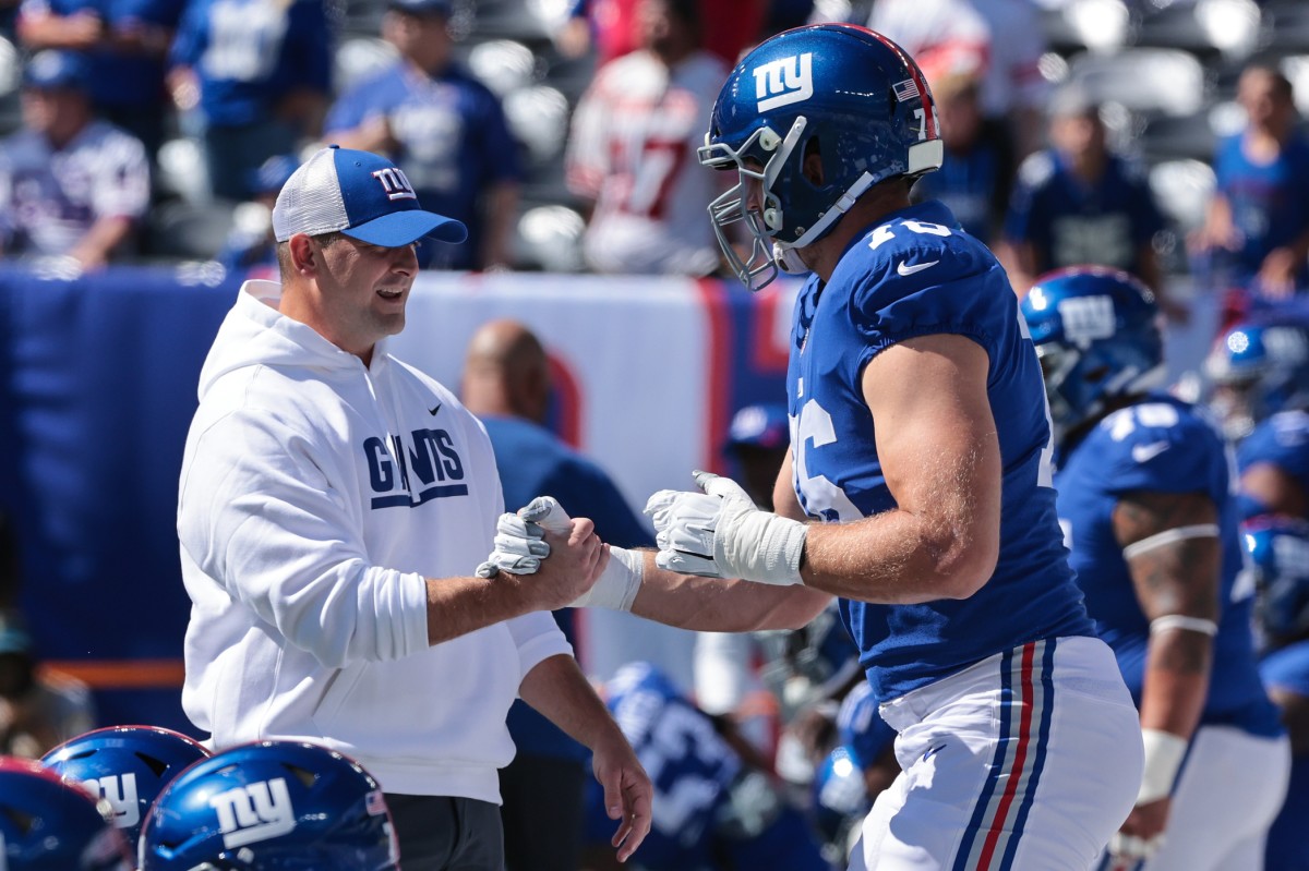Sep 26, 2021; East Rutherford, New Jersey, USA; New York Giants head coach Joe Judge shakes hands with offensive tackle Nate Solder (76) before the game against the Atlanta Falcons at MetLife Stadium.