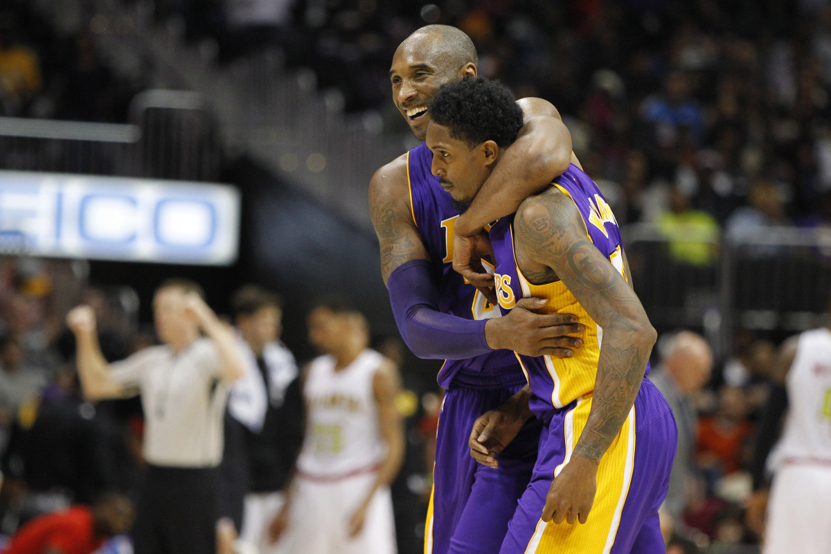 Los Angeles Lakers forward Kobe Bryant (24) hugs guard Louis Williams (23) against the Atlanta Hawks in the fourth quarter at Philips Arena.