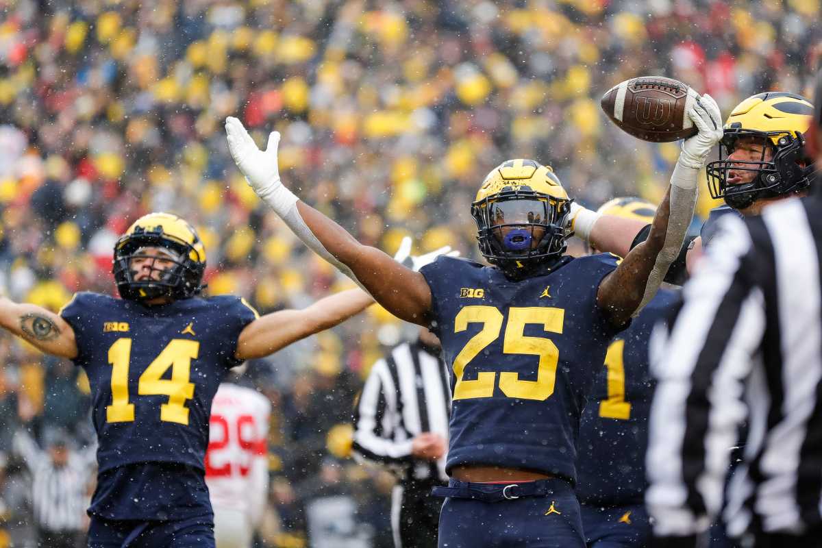 Michigan running back Hassan Haskins (25) celebrates scoring a touchdown against Ohio State during the second half at Michigan Stadium in Ann Arbor on Saturday, Nov. 27, 2021.
