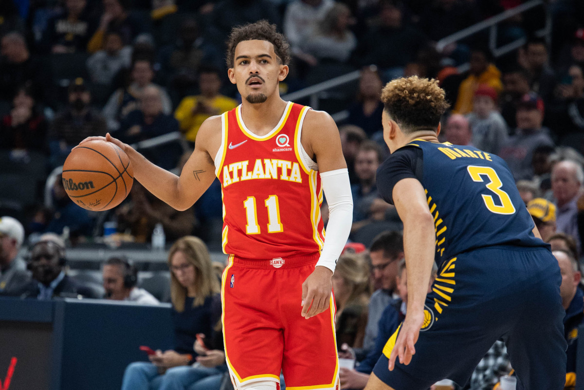 Atlanta Hawks guard Trae Young (11) dribbles the ball while Indiana Pacers guard Chris Duarte (3) defends in the first quarter at Gainbridge Fieldhouse.