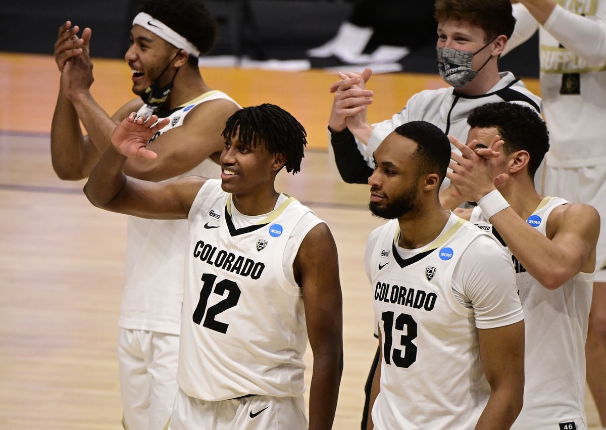 Mar 20, 2021; Indianapolis, Indiana, USA; Colorado Buffaloes players including Jabari Walker (12) and Dallas Walton (13) celebrate after defeating the Georgetown Hoyas during the first round of the 2021 NCAA Tournament at Hinkle Fieldhouse. Mandatory Credit: Marc Lebryk-USA TODAY Sports