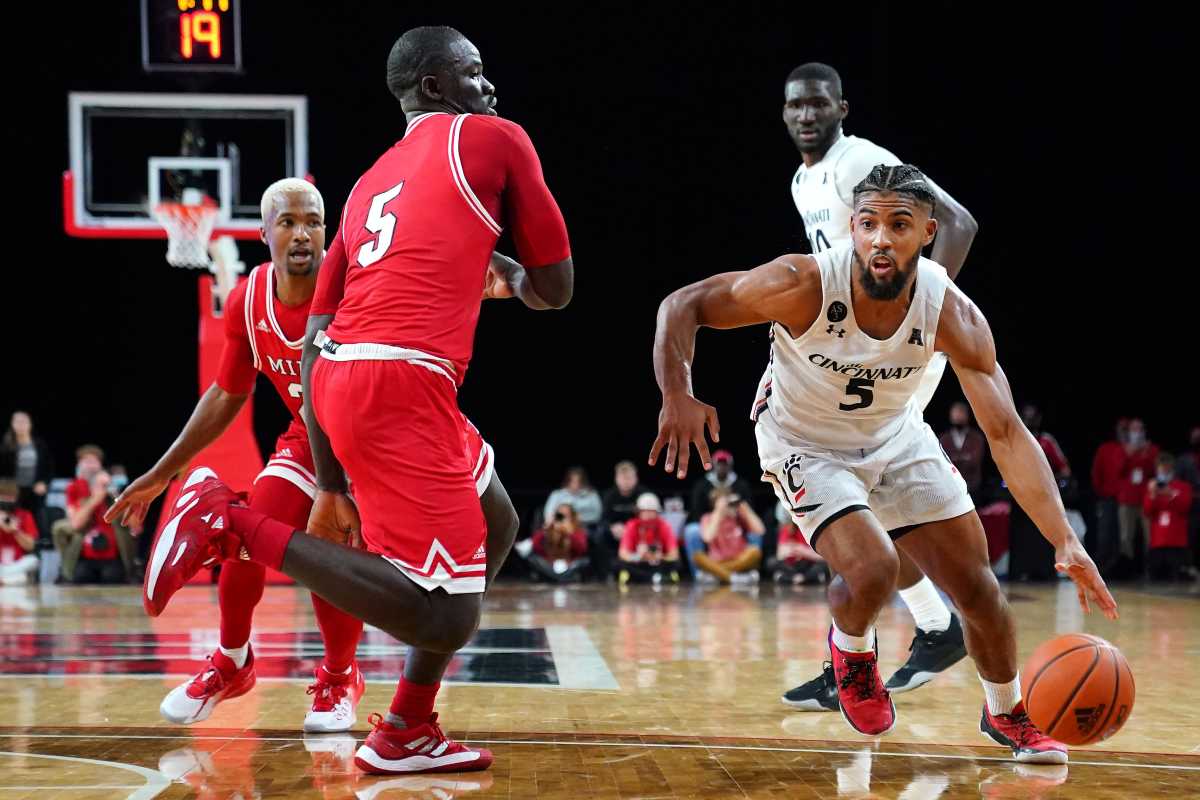 Cincinnati Bearcats guard David DeJulius (5) drives to the basket as Miami (Oh) Redhawks forward Precious Ayah (5) defends in the second half of an NCAA men's college basketball game, Wednesday, Dec. 1, 2021, at Millett Hall in Oxford, Ohio. The Cincinnati Bearcats won, 59-58. Cincinnati Bearcats At Miami Oh Redhawks Dec 1