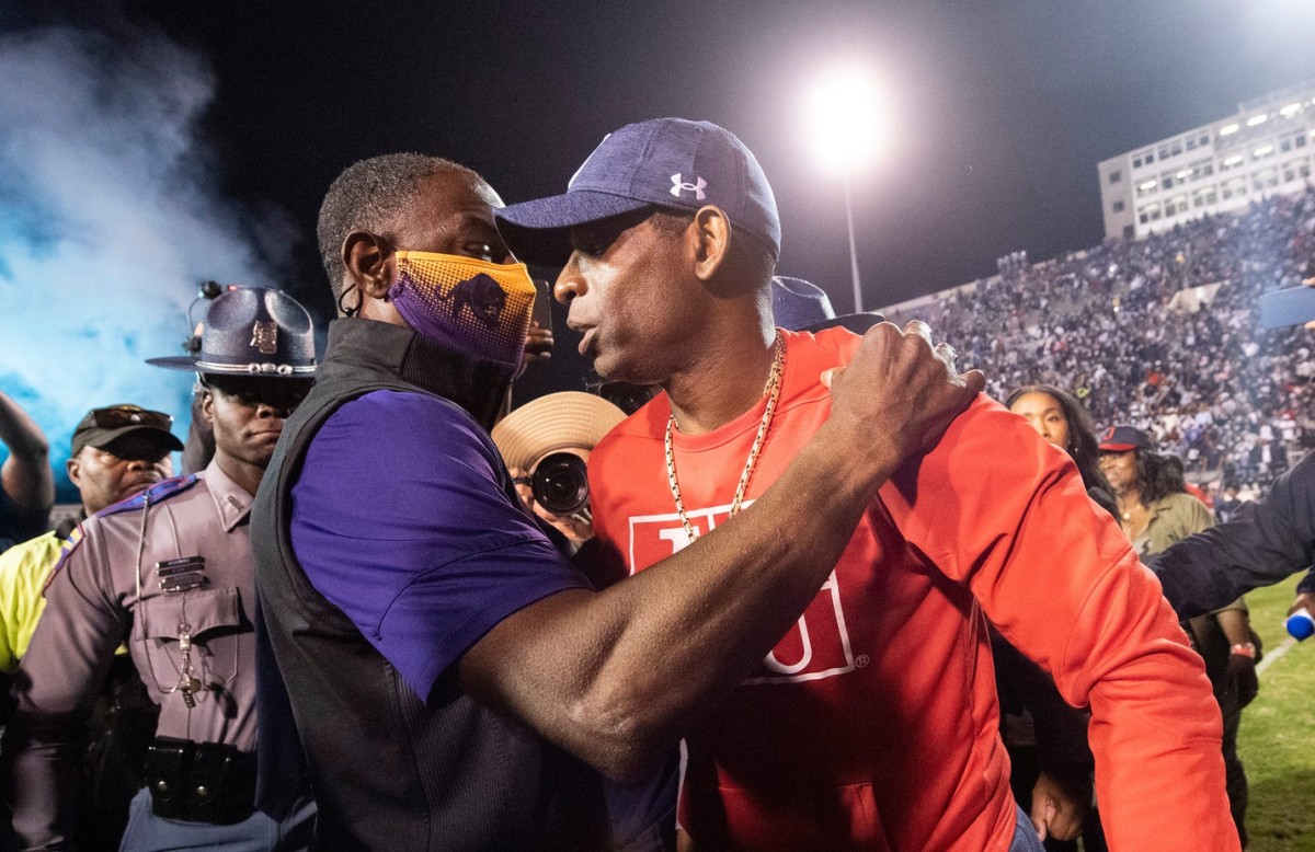 Prairie View A&M head coach Eric Dooley, left, and JSU head coach Deion Sanders, right