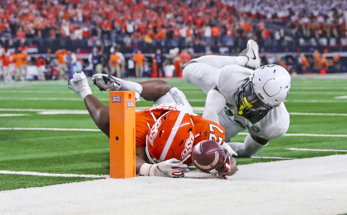 Dec 4, 2021; Arlington, TX, USA; Baylor Bears safety Jairon McVea (42) stops Oklahoma State Cowboys running back Dezmon Jackson (27) from scoring a touchdown during the fourth quarter of the Big 12 Conference championship game at AT&T Stadium.