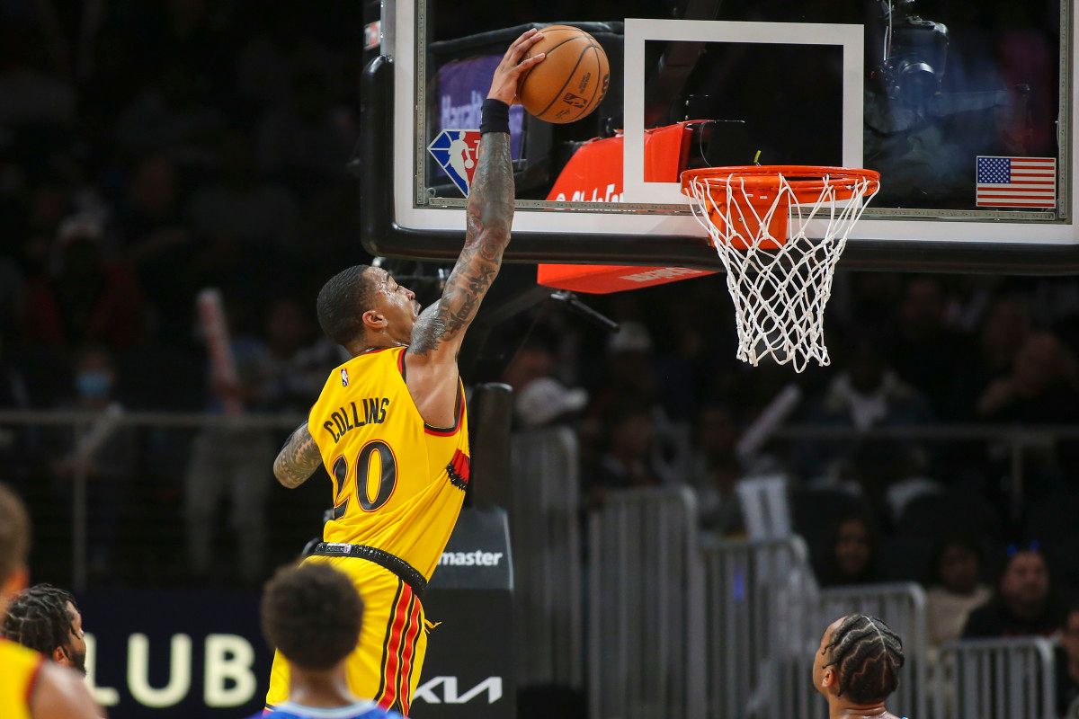 Atlanta Hawks forward John Collins (20) dunks against the Charlotte Hornets in the second quarter at State Farm Arena.