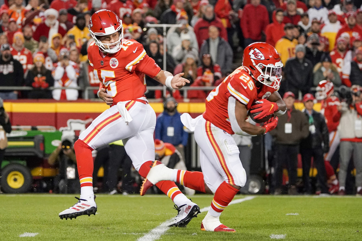 Dec 5, 2021; Kansas City, Missouri, USA; Kansas City Chiefs quarterback Patrick Mahomes (15) hands off to running back Clyde Edwards-Helaire (25) against the Denver Broncos during the first half at GEHA Field at Arrowhead Stadium. Mandatory Credit: Denny Medley-USA TODAY Sports