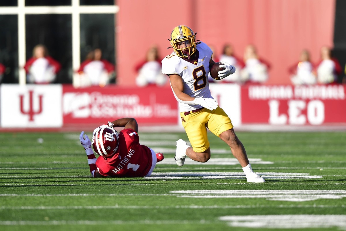 Nov 20, 2021; Bloomington, Indiana, USA; Minnesota Golden Gophers running back Ky Thomas (8) evades a tackle by Indiana Hoosiers defensive back Devon Matthews (1) during the first quarter at Memorial Stadium.