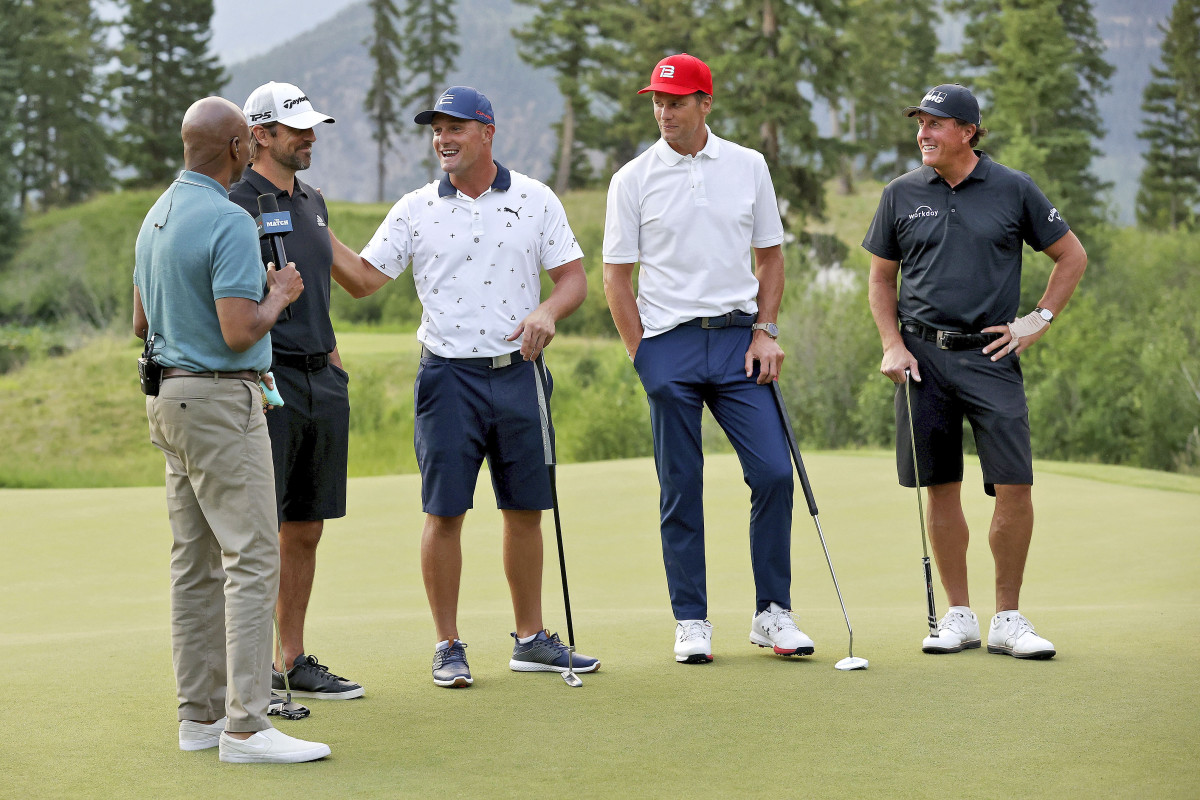 Aaron Rodgers, Bryson Dechambeau, Tom Brady and Phil Mickelson stand to be interviewed at their golf match.