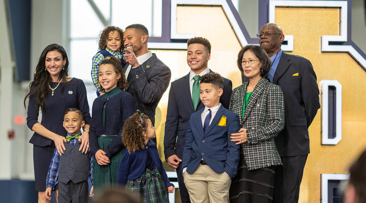 Notre Dame Fighting Irish head football coach Marcus Freeman poses for photos with his family.