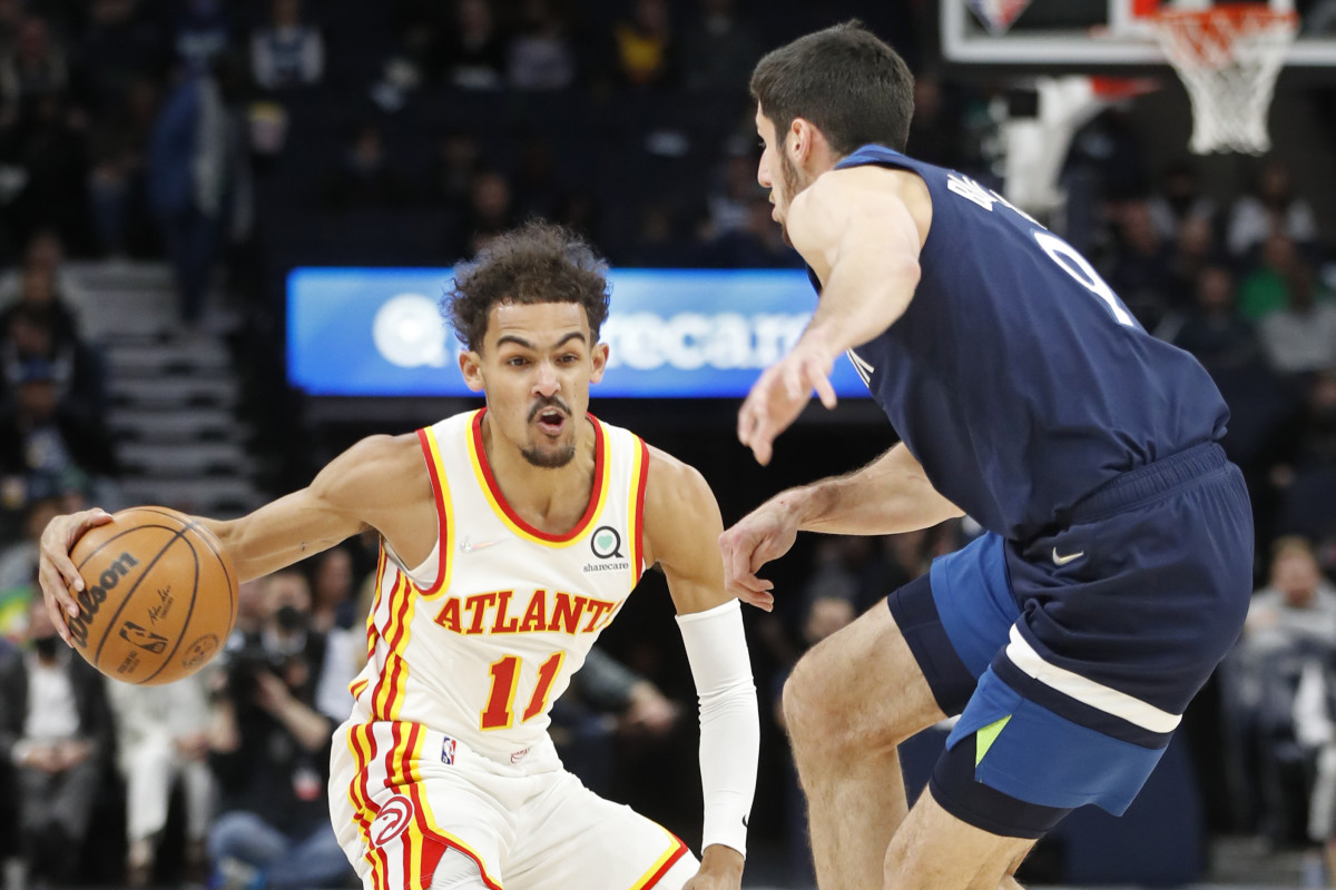 Atlanta Hawks guard Trae Young (11) brings the ball around Minnesota Timberwolves guard Leandro Bolmaro (9) in the first quarter at Target Center.