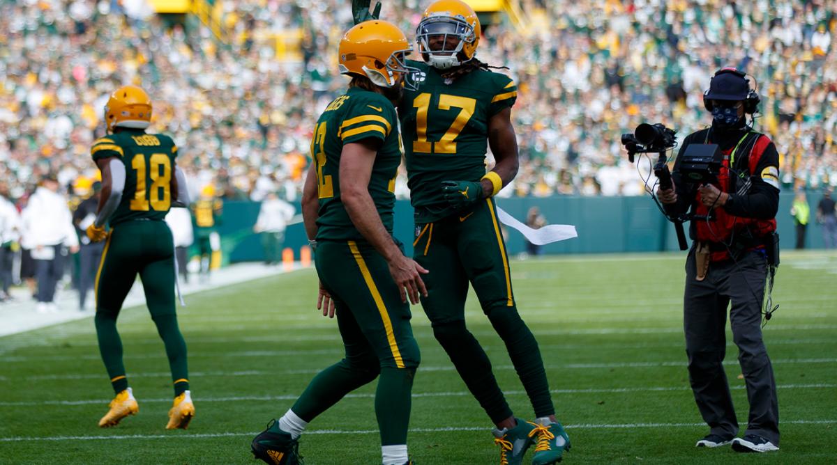 Oct 24, 2021; Green Bay, Wisconsin, USA; Green Bay Packers wide receiver Davante Adams (17) celebrates with quarterback Aaron Rodgers (12) after scoring a touchdown during the first quarter against the Washington Football Team at Lambeau Field.