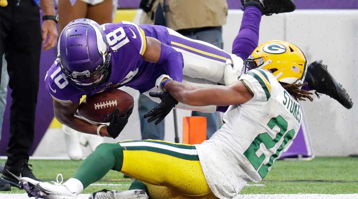 Minnesota Vikings wide receiver Justin Jefferson (18) dives across the goal line to score a touchdown against Green Bay Packers cornerback Eric Stokes (21) in the fourth quarter. during their football game Sunday, November 21, 2021, at U.S. Bank Stadium in Minneapolis, Min. The Vikings scored a two point conversion on the next play.
