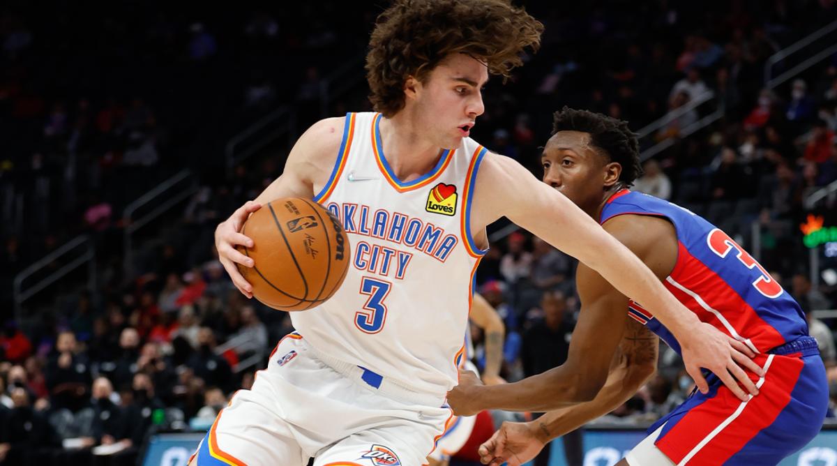 Dec 6, 2021; Detroit, Michigan, USA; Oklahoma City Thunder guard Josh Giddey (3) dribbles on Detroit Pistons guard Saben Lee (38) in the first half at Little Caesars Arena.