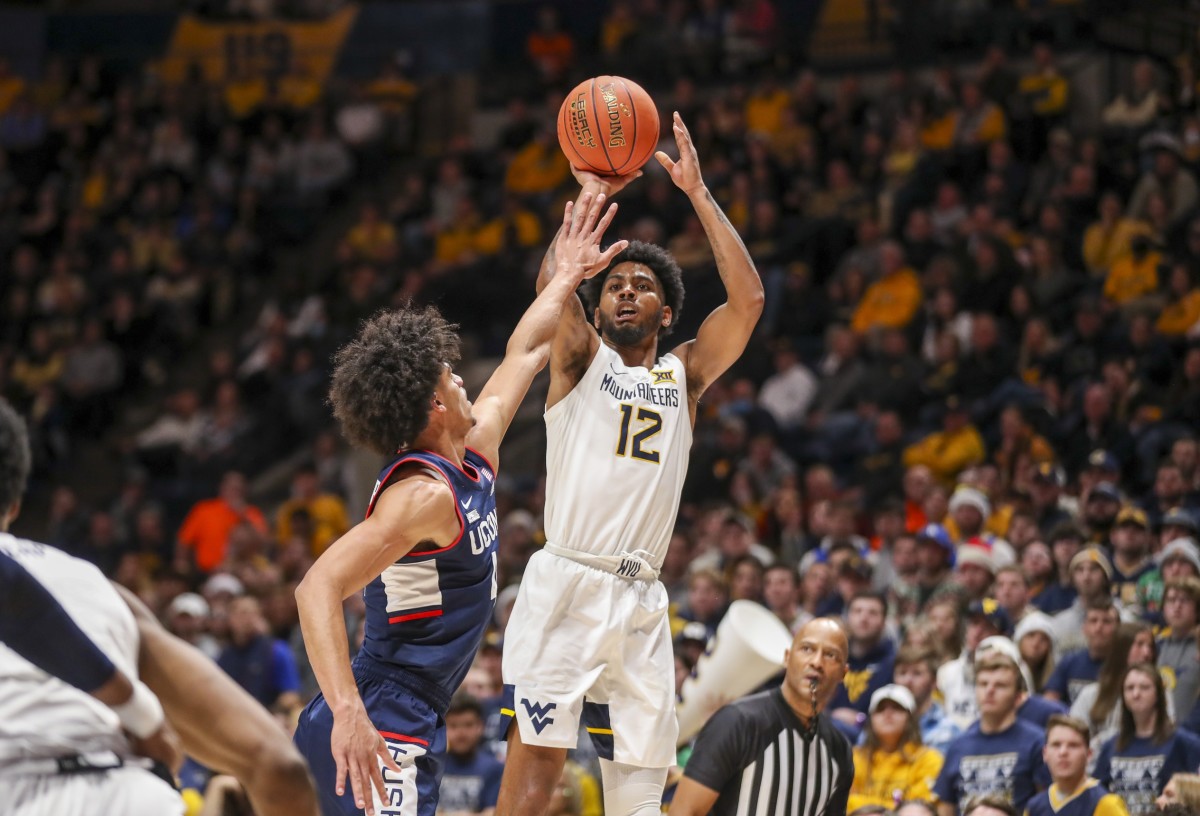 Dec 8, 2021; Morgantown, West Virginia, USA; West Virginia Mountaineers guard Taz Sherman (12) shoots during the second half against the Connecticut Huskies at WVU Coliseum. Mandatory Credit: