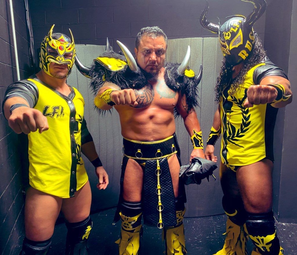 Luchador Rush poses with La Bestia del Ring and Dragon Lee