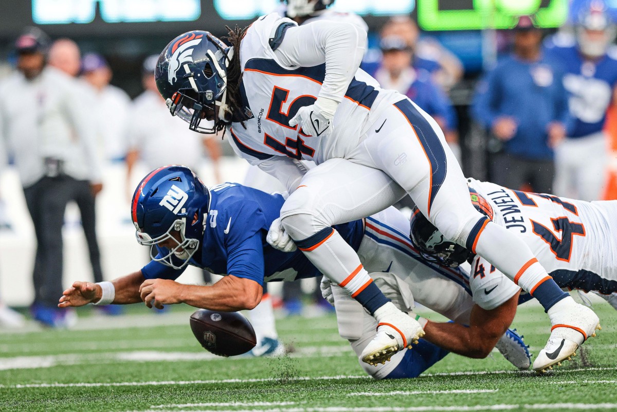 Denver Broncos linebacker A.J. Johnson (45) forces a fumble on New York Giants quarterback Daniel Jones (8) with inside linebacker Josey Jewell (47) during the second half at MetLife Stadium.