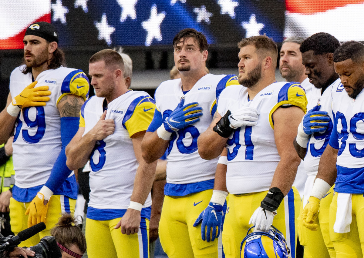 Michael Hoecht and Rams teammates stand for the national anthem before a game