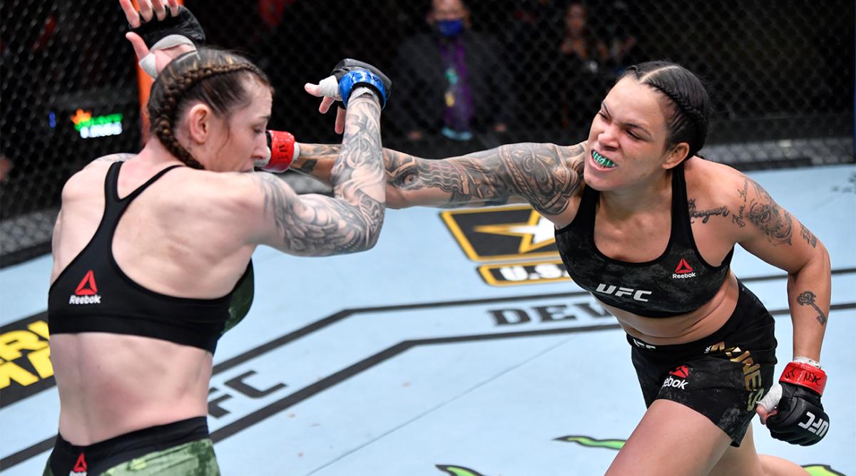 Mar 6, 2021; Las Vegas, NV, USA; Amanda Nunes of Brazil punches Megan Anderson of Australia in their UFC featherweight championship fight during the UFC 259 event at UFC APEX on March 06, 2021 in Las Vegas, Nevada.