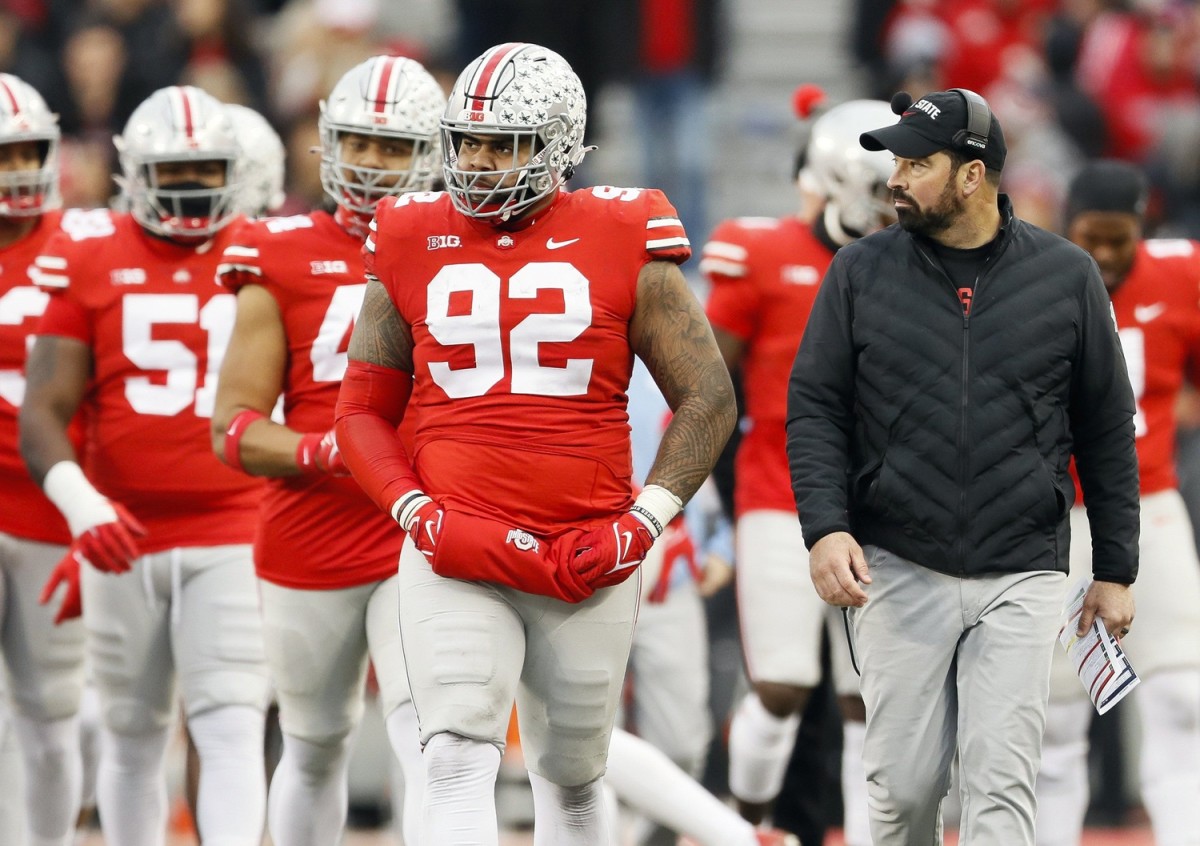 Ohio State Buckeyes defensive tackle Haskell Garrett (92) walks beside head coach Ryan Day during the third quarter of the NCAA football game at Ohio Stadium in Columbus on Saturday, Nov. 20, 2021.