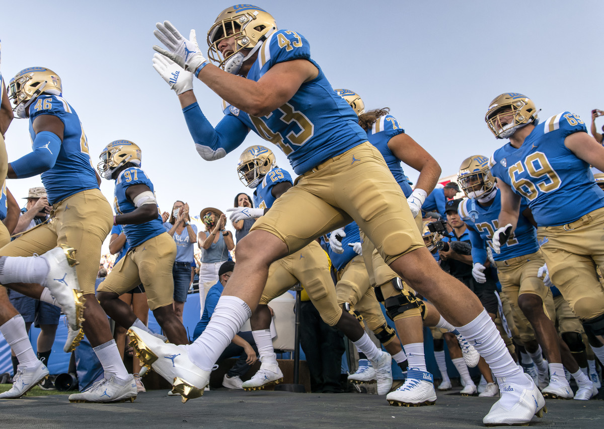 UCLA players take the field at the Rose Bowl before upsetting LSU.