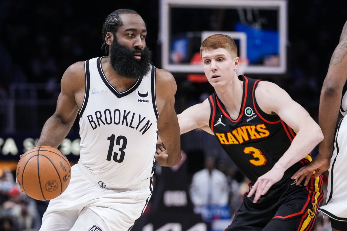 Brooklyn Nets guard James Harden (13) dribbles in front of Atlanta Hawks guard Kevin Huerter (3) during the first half at State Farm Arena.