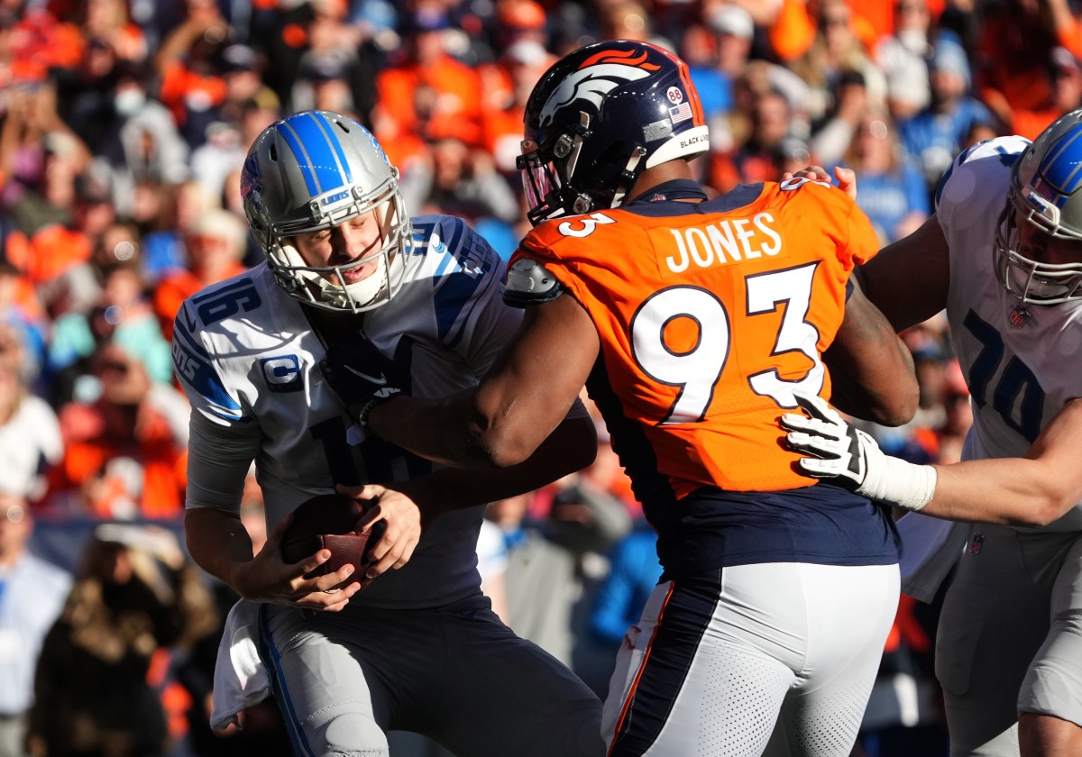 Denver Broncos defensive end Dre'Mont Jones (93) sacks Detroit Lions quarterback Jared Goff (16) in the first quarter at Empower Field at Mile High.