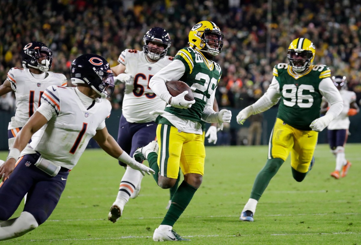 Green Bay Packers cornerback Rasul Douglas (29) intercepts a pass intended for Chicago Bears wide receiver Darnell Mooney (11) and runs it back for a touchdown in the second quarter during their football game Sunday, December 12, 2021, at Lambeau Field in Green Bay, Wis.