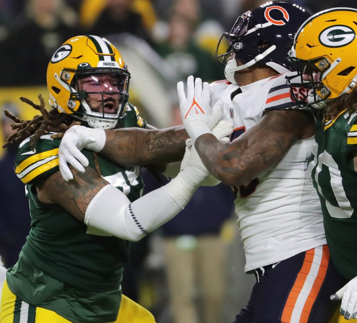 Green Bay Packers guard Billy Turner (77) blocks Chicago Bears linebacker Bruce Irvin (55) during the first quarter of their game Sunday, December 12, 2021 at Lambeau Field in Green Bay, Wis.