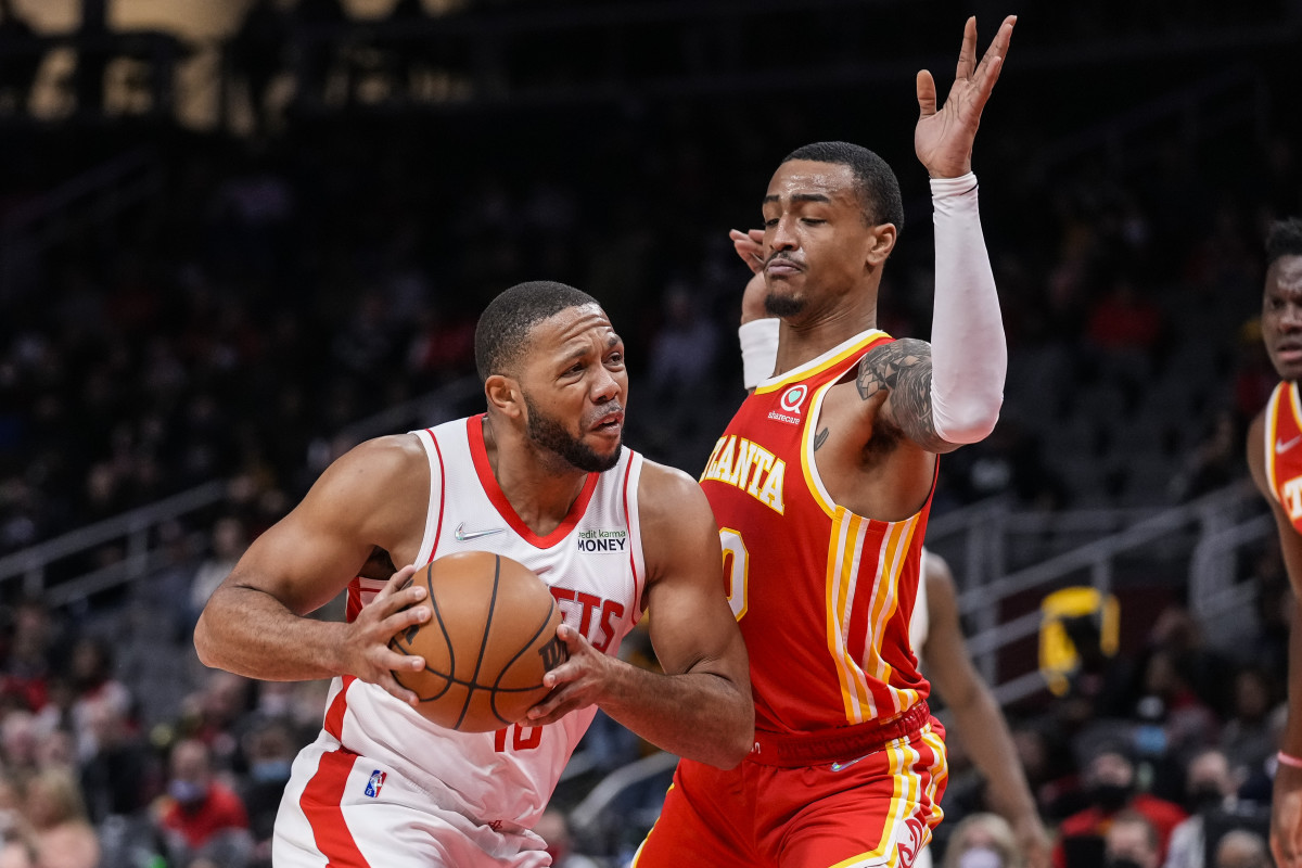 Houston Rockets guard Eric Gordon (10) is defended by Atlanta Hawks forward John Collins (20) during the first half at State Farm Arena.