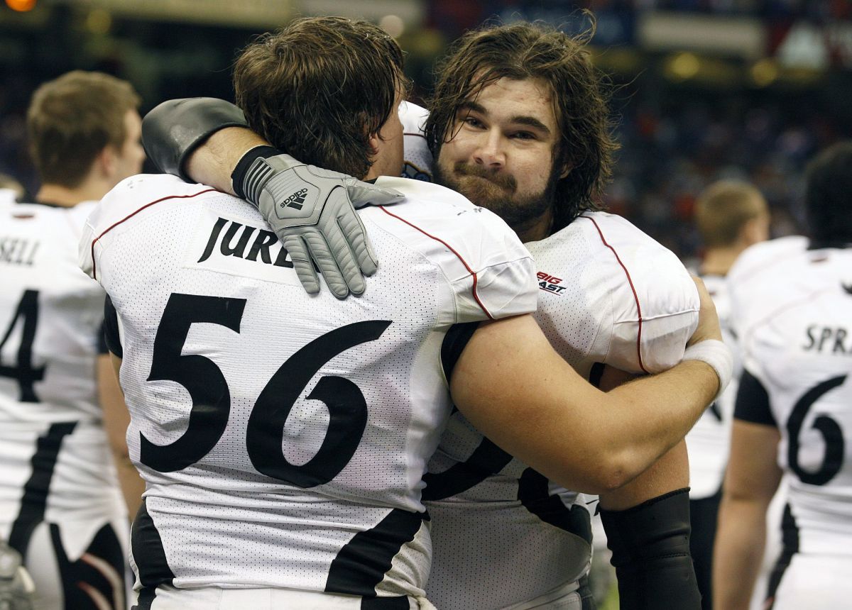 UC.FLORIDA.SPORTS.FRIDAY.JANUARY 1, 2010. University of Cincinnati's Chris Jurek, left, and Jason Kelce console one another after The Bearcats lost 51-24 to the Florida Gators in the Sugar Bowl at the Louisiana Superdome in New Orleans. Photo shot Friday January 1, 2010. The Enquirer/Cara Owsley Sugar Secondhalf10