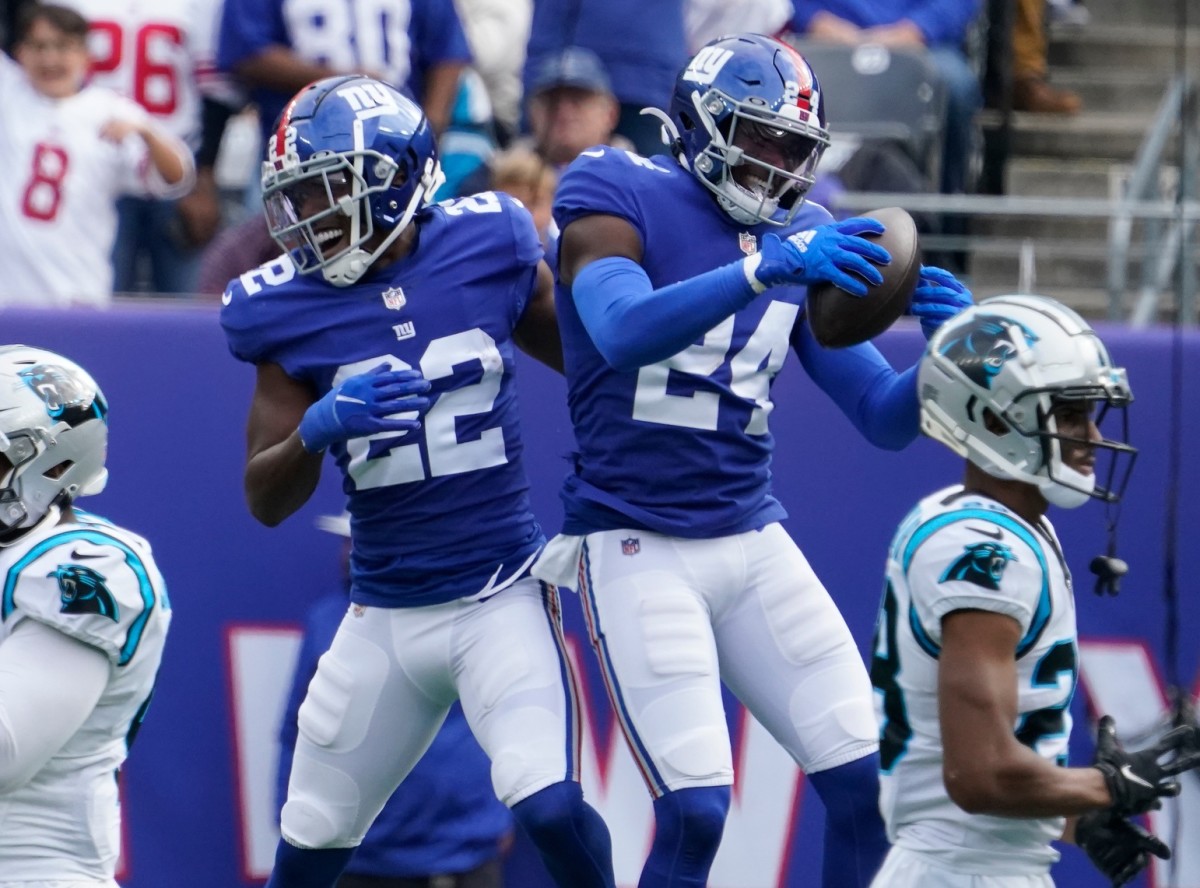 Oct 24, 2021; East Rutherford, NJ, USA; New York Giants cornerback James Bradberry (24) celebrates a 2nd quarter interception with New York Giants cornerback Adoree' Jackson (22) against the Carolina Panthers at MetLife Stadium.