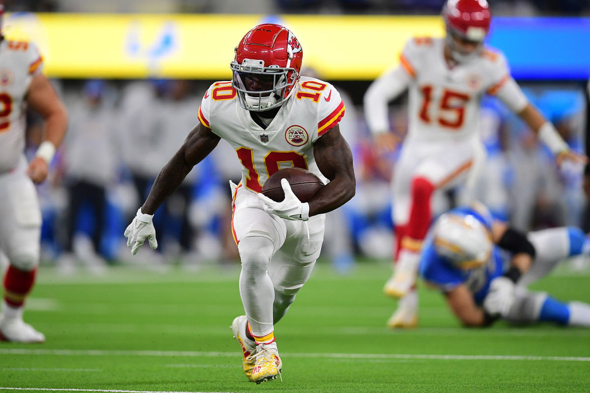 Dec 16, 2021; Inglewood, California, USA; Kansas City Chiefs wide receiver Tyreek Hill (10) runs the ball against the Los Angeles Chargers during the first half at SoFi Stadium. Mandatory Credit: Gary A. Vasquez-USA TODAY Sports