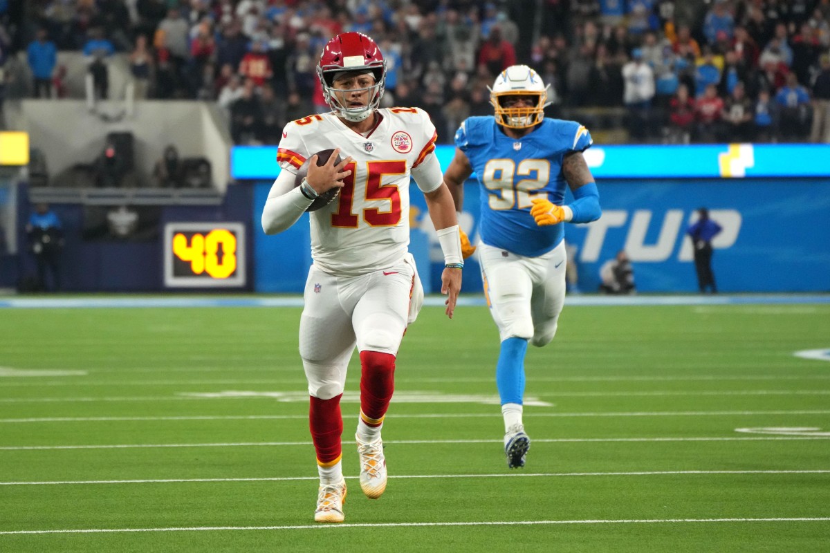 Dec 16, 2021; Inglewood, California, USA; Kansas City Chiefs quarterback Patrick Mahomes (15) runs the ball against the Los Angeles Chargers in overtime at SoFi Stadium. Mandatory Credit: Kirby Lee-USA TODAY Sports