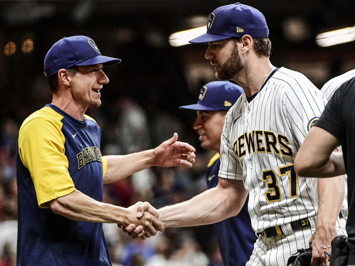 Sep 4, 2021; Milwaukee, Wisconsin, USA;  Milwaukee Brewers pitcher Adrian Houser (37) is congratulated by manager Craig Counsell (left) after pitching a complete game shutout to beat the St. Louis Cardinals at American Family Field.