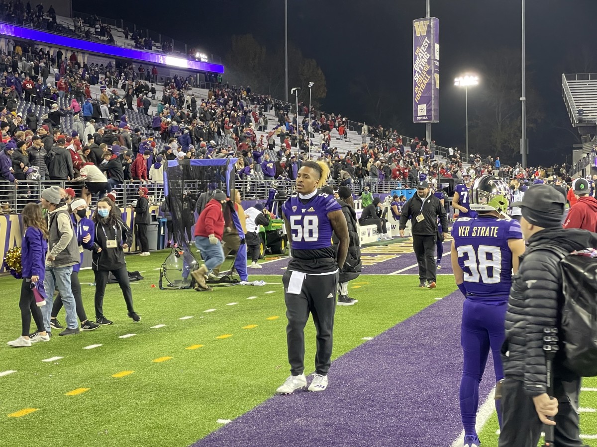 An injured Zion Tupuola-Fetui leaves the field following at the Apple Cup.