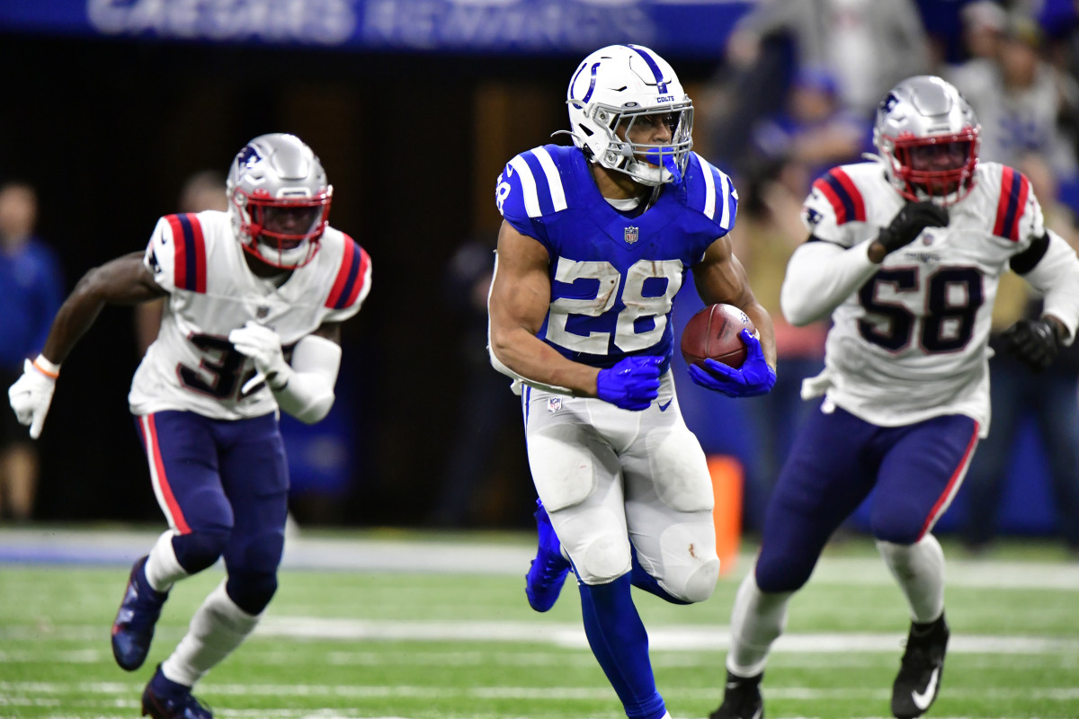 Dec 18, 2021; Indianapolis, Indiana, USA; Indianapolis Colts running back Jonathan Taylor (28) runs the ball for a 69 yard touchdown during the second half against the New England Patriots at Lucas Oil Stadium. Colts won 27-17. Mandatory Credit: Marc Lebryk-USA TODAY Sports